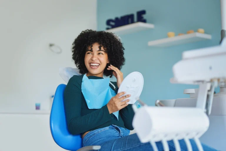 Black woman smiling in a dental exam chair.