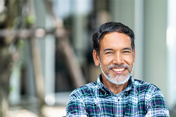 Stock image of a man smiling with white teeth.